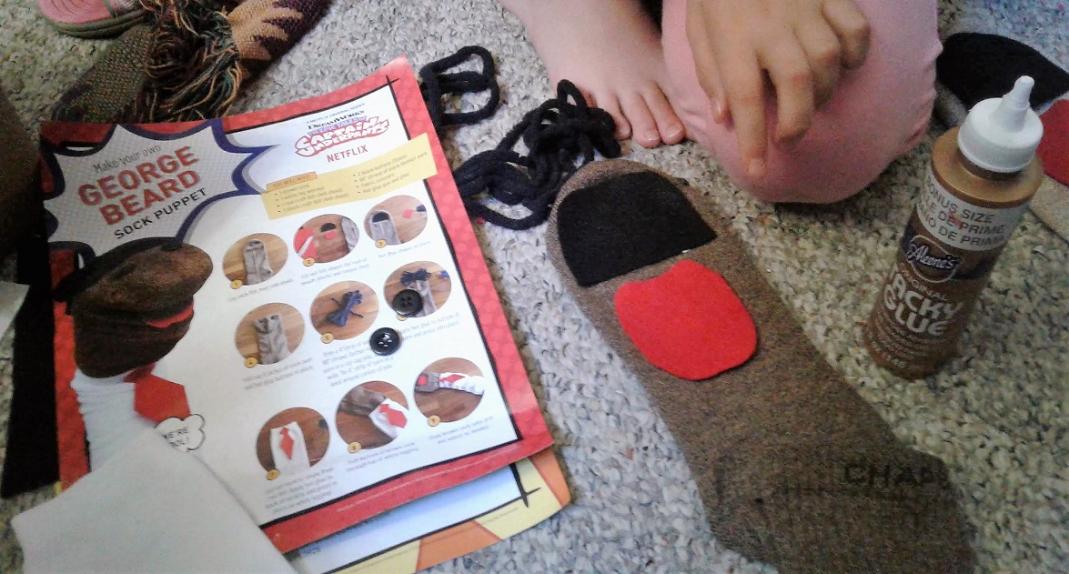 Directions and pieces of felt laid out on a sock
