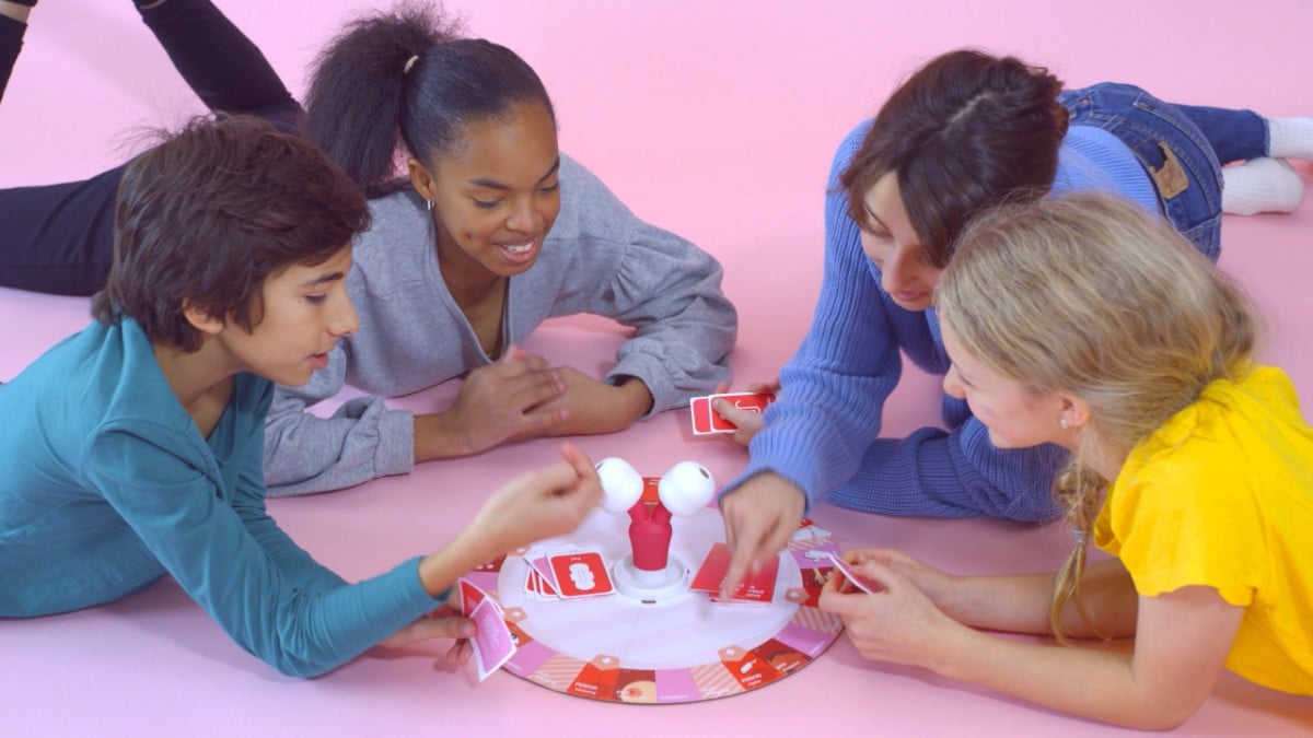 The Period Game being played by a white girl, a black girl, a brown skinned boy, and a white adult