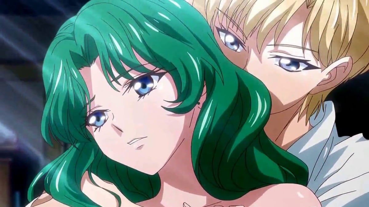a green haired girl leans against a blonde androgynous figure