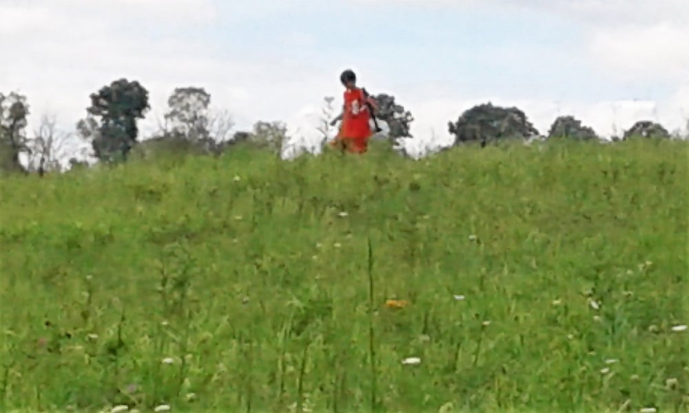 12yo carries a model rocket over the crest of a hill