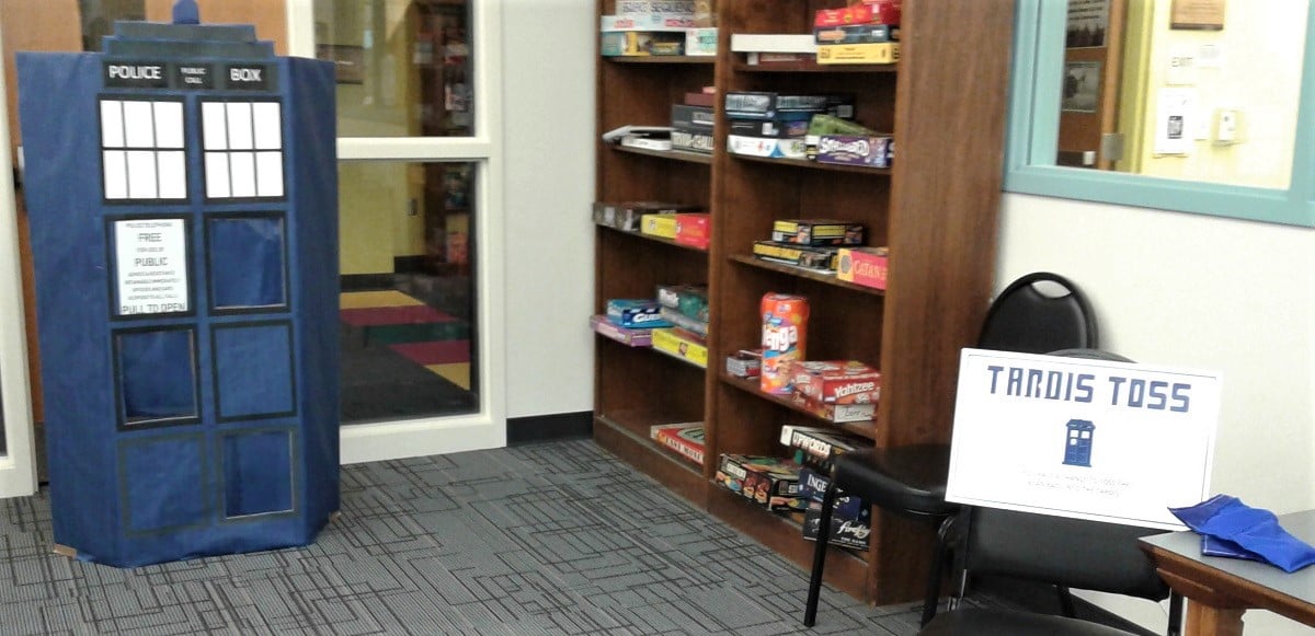 Cardboard TARDIS with a sign beside it reading "TARDIS TOSS"