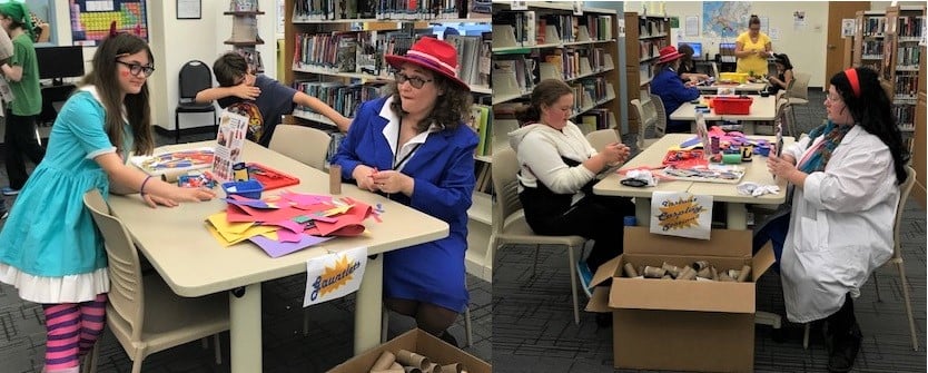 Long tables full of art supplies where costumed people are making cardboard cuffs and masks