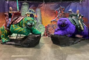 two people sitting on green Cringer from He-Man and Panthor from Skeletor