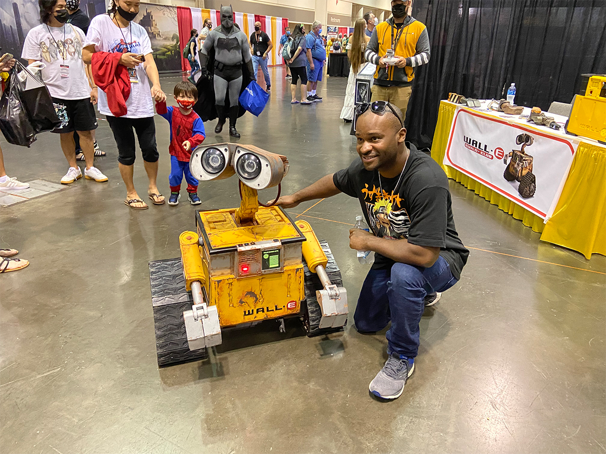 WALL-E from the Pixar Disney movie robot with convention attendee
